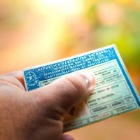 August 28, 2019, Brazil. Man holding document "Carteira Nacional de Habilitação" (CNH). A driver's license attests to a citizen's ability to drive land motor vehicles.